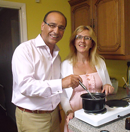 Photo of Tracy with Theo Paphitis in her kitchen making the creams
